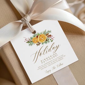 May include: A white gift tag with a watercolour illustration of oranges, cinnamon sticks, and greenery. The text on the tag reads "Holiday Simmering Potpourri Add all ingredients to a sauce pan. Cover with 2 cups of water, simmer on low heat, add water as needed. Enjoy. The Collins"