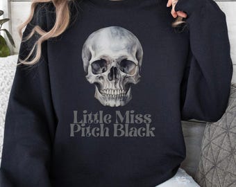 May include: Black sweatshirt with a white skull graphic and the text "Little Miss Pitch Black".