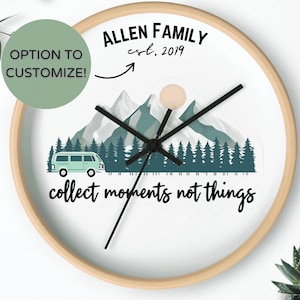 May include: A round wall clock with a light wood frame. The clock face features a mountain and forest scene with a teal camper van. Text includes "ALLEN FAMILY est. 2019" and "collect moments not things."