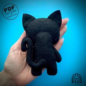 May include: A black felt cat doll with a curved tail, ears, and a small body. The doll is held in a hand against a blue background. Text on the image reads "PDF PATTERN & INSTRUCTIONS" and "SVG".