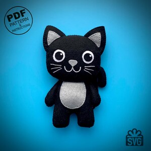 May include: A black felt cat plushie with gray accents on the ears, chest, and nose. The cat has large white eyes, white whiskers, and a stitched smile. The image includes text that says "PDF PATTERN & INSTRUCTIONS" and "SVG".