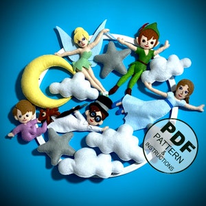 May include: A felt mobile with a crescent moon, stars, clouds, and characters from Peter Pan and Tinkerbell. The characters include Peter Pan, Tinkerbell, Wendy, and Captain Hook. The mobile is white with a light blue background. The text "PDF PATTERN & INSTRUCTIONS" is on a white circle with a black border.