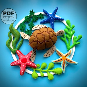 May include: A felt craft kit featuring a brown turtle, two starfish, a green seaweed, and a blue starfish. The kit includes a PDF pattern and instructions.