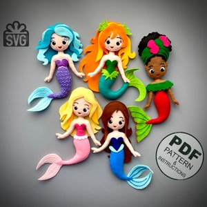 May include: A collection of six felt mermaid dolls with various hair colors and tail designs. Each doll has a unique color scheme, including blue, orange, yellow, brown, and green. The dolls are arranged on a gray background. The image also includes the text "PDF PATTERN & INSTRUCTIONS".