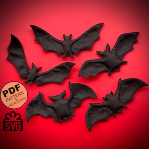 May include: Five black felt bats on a red background. The bats are all different sizes and shapes. The image includes the text "PDF PATTERN & INSTRUCTIONS" and "SVG".