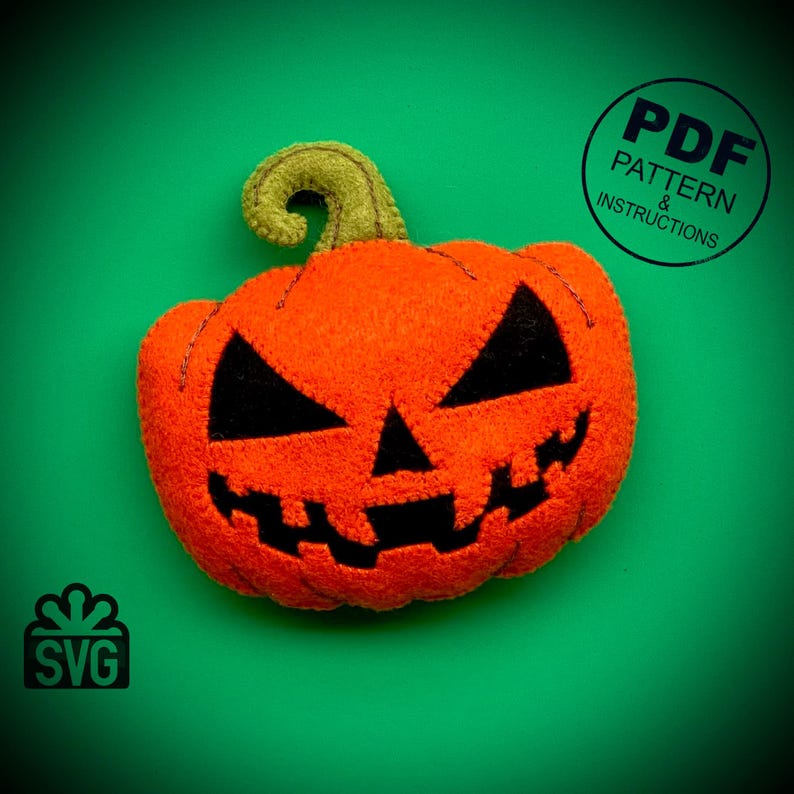 May include: A felt orange pumpkin with a black stitched-on face. The pumpkin has a green felt stem. The image includes the text "PDF PATTERN & INSTRUCTIONS" and "SVG".