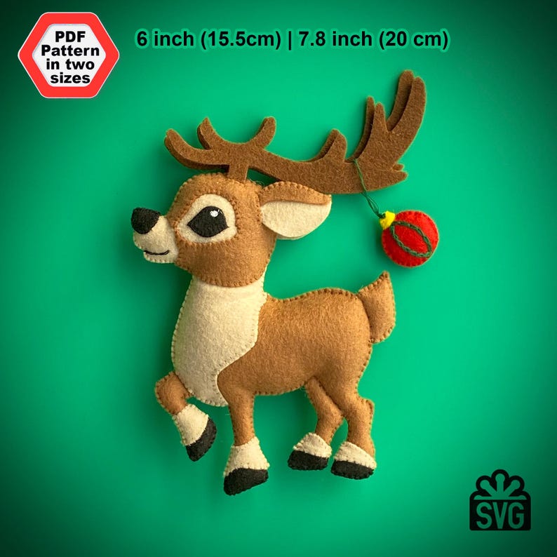 May include: A felt reindeer ornament with a red and yellow ornament hanging from its antlers. The reindeer is brown with a white belly and black hooves. The ornament is 6 inches (15.5 cm) or 7.8 inches (20 cm) tall.