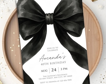 May include: A black watercolor bow design adorns a white invitation card. The card announces Amanda's 40th birthday celebration, including the date, time, and location. The invitation is set on a wooden tray.