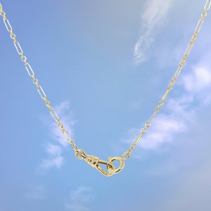 Quinney Collection's handcrafted gold filled Albert necklace, features a classic trombone link and a distinctive vintage style dog clip clasp. This piece is a modern homage to the timeless pocket watch chain, offering both style and practicality.