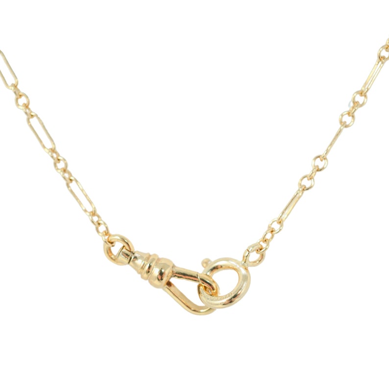 Quinney Collection's handcrafted gold filled Albert necklace, features a classic trombone link and a distinctive vintage style dog clip clasp. This piece is a modern homage to the timeless pocket watch chain, offering both style and practicality.