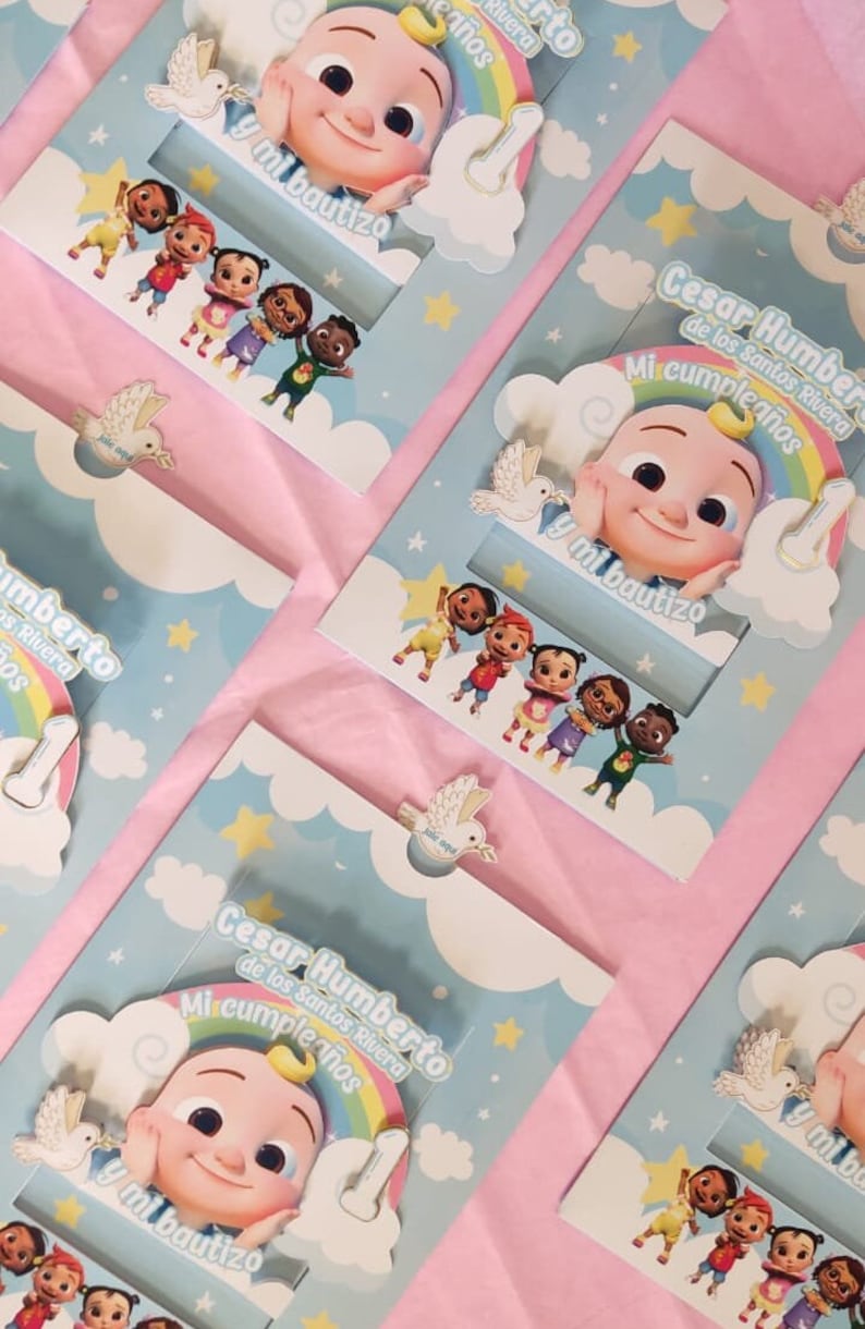 May include: A blue and white invitation card with a rainbow and a cartoon baby character. The text on the card reads "Cesar Humberto de los Santos Rivera Mi cumpleanos y mi bautizo".