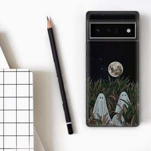 May include: A black phone case with a night sky design featuring a full moon, stars, and two ghosts in a field of tall grass.