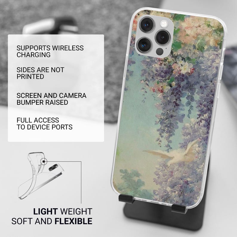 May include: A clear phone case with a floral design featuring a white bird flying through a purple and pink flower arrangement. The case has a raised bumper to protect the screen and camera. It supports wireless charging and has full access to device ports. The case is lightweight and flexible.