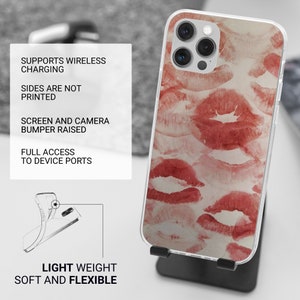 May include: A clear phone case with a red and white lipstick print design. The case is compatible with wireless charging and has raised edges to protect the screen and camera.