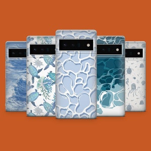 May include: Five different phone cases with ocean-themed designs. The cases feature a variety of sea creatures, including sea turtles, starfish, and jellyfish. The cases are all white with blue accents.