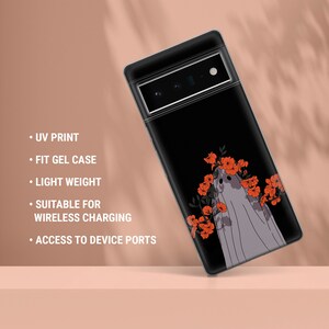 May include: A black phone case with a ghost design and red flowers. The case is made of gel and has a UV print. It is suitable for wireless charging and has access to device ports.