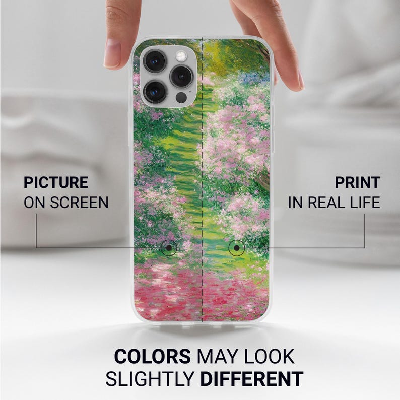 May include: A white iPhone case with a printed image of a Monet-style painting of a garden path with pink flowers. The text "PICTURE ON SCREEN" and "PRINT IN REAL LIFE" is on either side of the case. The text "COLORS MAY LOOK SLIGHTLY DIFFERENT" is below the case.