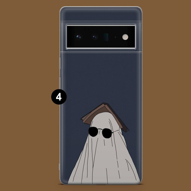 May include: A phone case with a dark blue background and a white ghost wearing sunglasses and a book on its head.