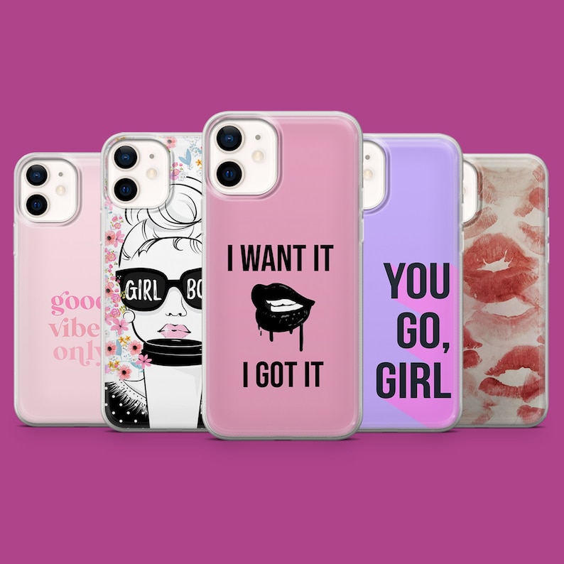 May include: Five different phone cases with various designs. The cases are clear and show the phone's camera lens. The designs include a woman with sunglasses, lips with dripping paint, a floral pattern, lips with a watercolor effect, and the text "You Go, Girl".