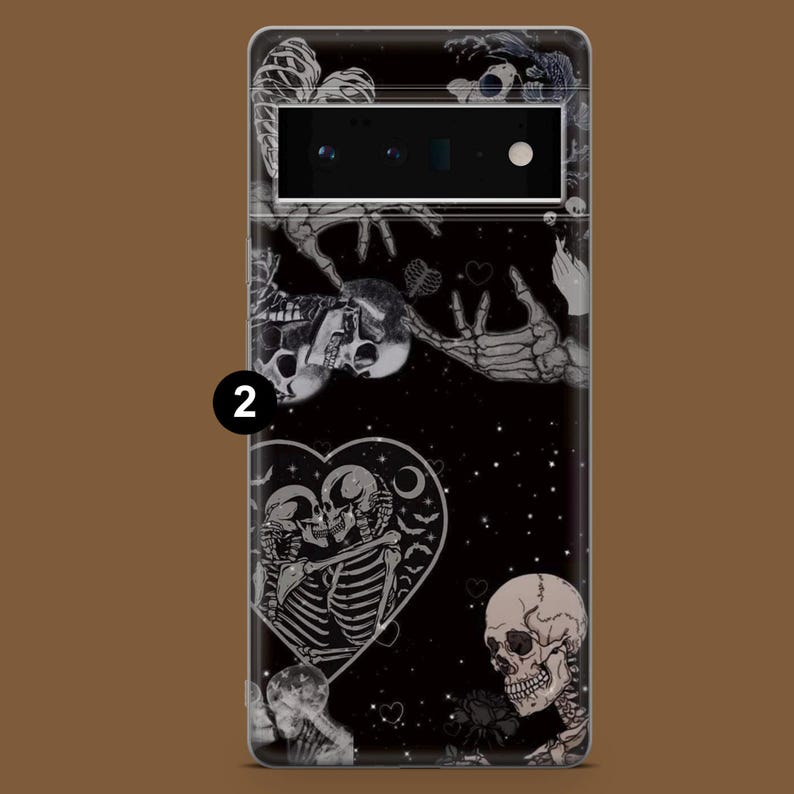 May include: Black phone case featuring a skeleton couple embracing within a heart, surrounded by other skeletons and stars. The case has a black background with a glittery effect.