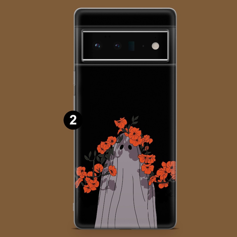 May include: A black phone case with a white ghost wearing a crown of orange flowers. The ghost is outlined in black and the flowers are filled in with orange.