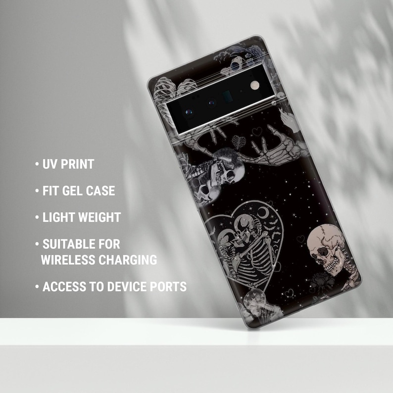 May include: Black phone case featuring a graphic print of skeletons and hearts. The case is compatible with wireless charging and has access to device ports.