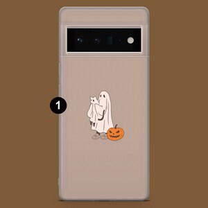 May include: A clear phone case with a white ghost holding a smaller white ghost and a jack-o'-lantern. The case is designed for a phone with a triple camera lens.