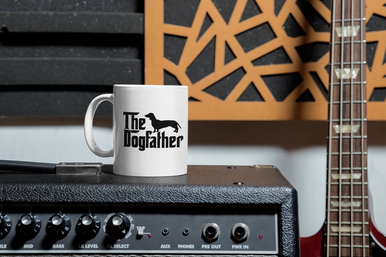 May include: A set of three ceramic mugs with a speckled, matte finish. The mugs are in shades of cream, light brown, and dark brown. Each mug has a simple, minimalist design and a rounded handle.