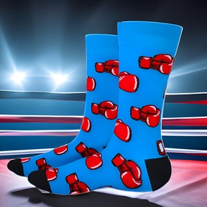 May include: A pair of blue socks with a red boxing glove pattern. The socks are in a boxing ring.