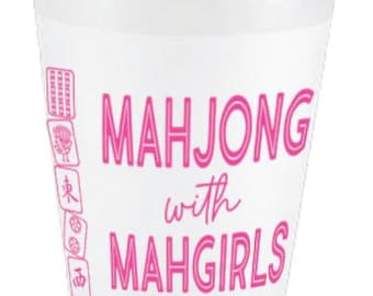 May include: White plastic cup with pink text that reads "Mahjong with Mahgirls". The cup has a pink design of mahjong tiles on the side.
