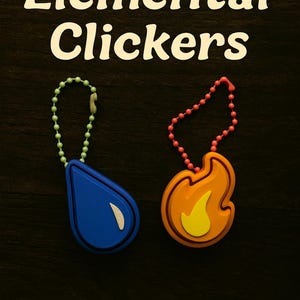 May include: Two keychains, one blue teardrop-shaped and one orange flame-shaped, with the text "Elemental Clickers" above them. The keychains have beaded chains in green and pink. The background is dark wood.