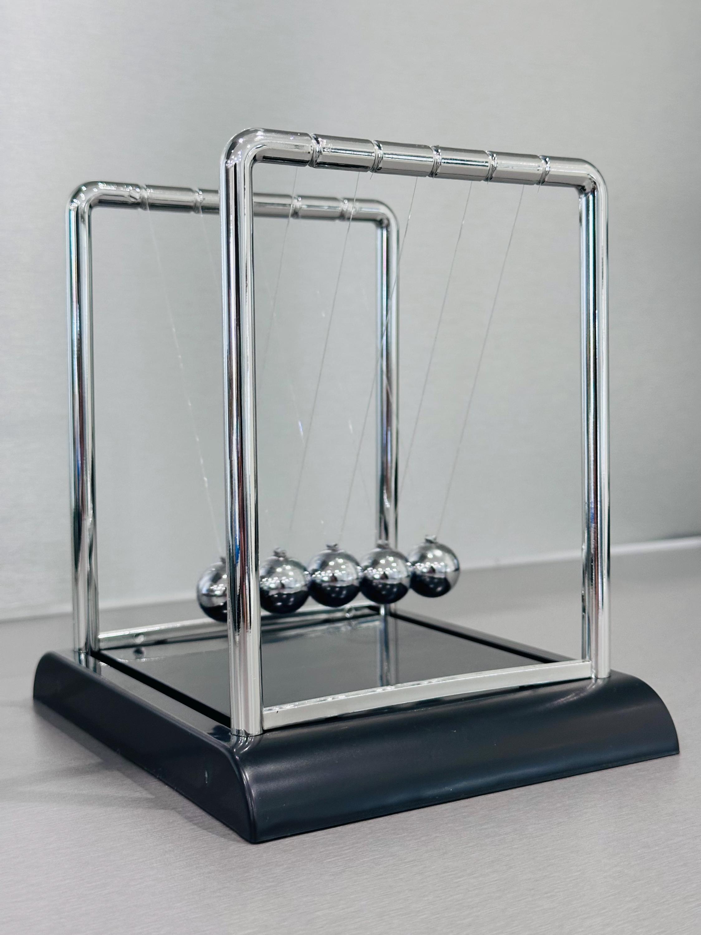 Newtons Cradle Made Of Glass And Stone High-Res Stock Photo - Getty Images