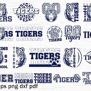 Puede incluir: Una colección de 16 diseños de temática de tigre en azul y blanco. Los diseños incluyen la palabra "Tigers" en varias fuentes y estilos, junto con imágenes de tigres, huellas de patas y balones de fútbol. Los diseños son perfectos para crear ropa personalizada, manualidades y decoración del hogar.