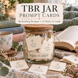 May include: A clear glass jar with a wooden lid containing numerous small square paper cards. The jar is tied with twine and a small heart charm. The cards feature printed text including 'A book with a cozy setting' and 'A book recommended by a friend'.