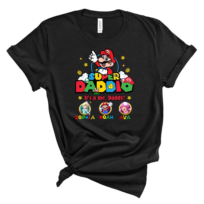 May include: Black t-shirt with a Super Daddie graphic featuring Mario from the Super Mario Bros. video game. The text "It's a me, Daddy!" is below the graphic. The names Sophia, Noah, and Ava are below the text.