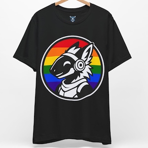 May include: Black t-shirt featuring a cartoon character with a rainbow circle design. The character has a white and black design with headphones. The t-shirt is hanging on a wooden hanger.