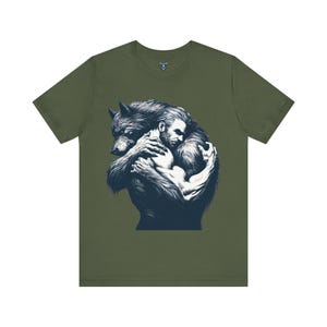 Purple shirt with a bestial werewolf holding a man with love and affection. Designed for lgbtqia community. Gay man and werewolf lovers. Werewolf love, shirt for werewolf lovers. Rugged sexy man and sexy werewolf hug.
