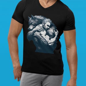A maroon tshirt with a furry werewolf lovingly hugging a handsome rugged man. Designed for the LGBTQ community. Monsters need love too. LGBTQ+ Werewolf pride tshirt. Werewolf male lover top, love the beast within. Beast lover. Monster Lover top.