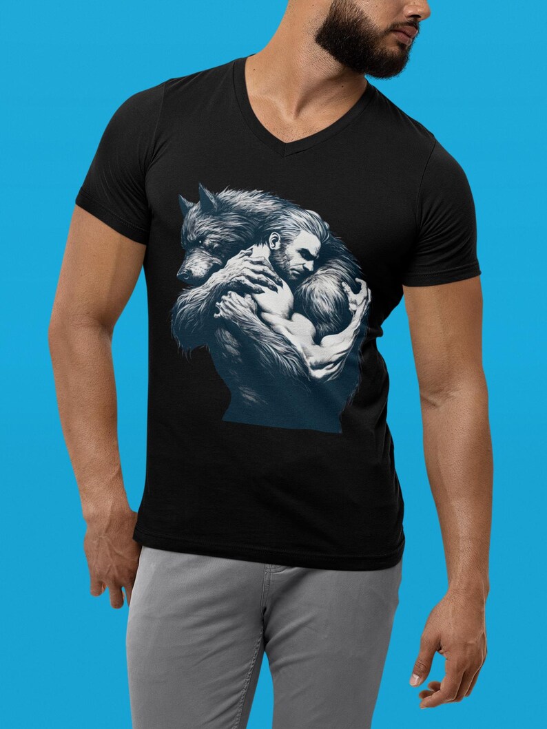 A maroon tshirt with a furry werewolf lovingly hugging a handsome rugged man. Designed for the LGBTQ community. Monsters need love too. LGBTQ+ Werewolf pride tshirt. Werewolf male lover top, love the beast within. Beast lover. Monster Lover top.