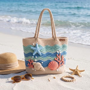 May include: A beige crochet tote bag featuring wavy stripes in light green and blue, decorated with a light blue starfish, coral-colored sea fan, and two seashells. The bag has two rope handles and a small rectangular tag on the upper right side.