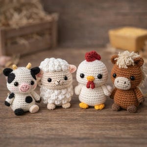 May include: Four crocheted farm animal figurines: a cow with black spots, a white sheep, a white chicken with a red comb, and a brown horse with a tan mane. The handmade toys are arranged on a wooden surface.