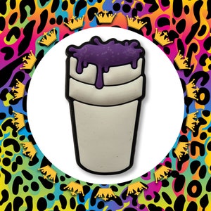 May include: A white styrofoam cup with a purple liquid dripping down the side. The cup is a popular design for a drink often referred to as "lean".