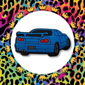 May include: A blue toy car with black detailing. The car has a spoiler and red taillights.