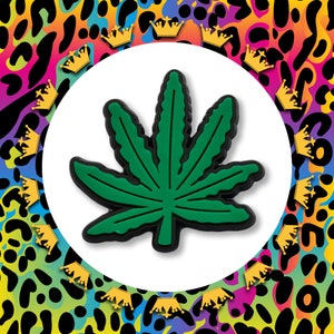 May include: A green marijuana leaf with seven points, outlined in black, against a white background.