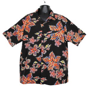 May include: Black button-down shirt with a vibrant floral pattern. The design features large, stylized flowers in shades of orange, red, yellow, and blue. The shirt has short sleeves and a classic collar, suitable for casual wear.