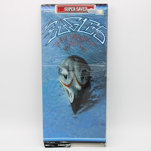 May include: A compact disc of the Eagles' album "Their Greatest Hits" in a plastic wrap. The album cover features the band's name in a stylized font above an illustration of an eagle's head against a blue background. The words "Super Saver" are at the top.