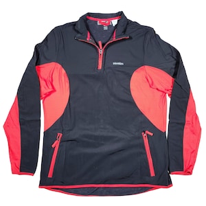 May include: Black and red athletic pullover with a quarter-zip closure. The long-sleeved top features red mesh panels on the sides and sleeves, with red zipper pockets and trim. The Ferrari logo is visible on the chest.