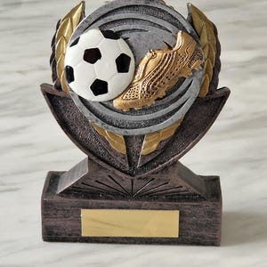 Personalised heavy 14 cm cast resin soccer trophy. Ideal prize, desk top item or ornament