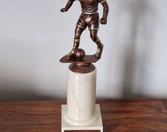 Personalised soccer figurine trophy. Figurine mounted on a grained beige coloured marble pedestal and a square marble base