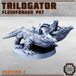May include: A grey, three-headed alligator creature with a mechanical, steampunk-style design. The creature is posed on a round base and has a textured, scaly appearance. The text "TRILOGATOR FLESHFORGED PET" is visible at the top of the image.